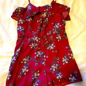 Maroon romper with a key hole bow tie on the front.